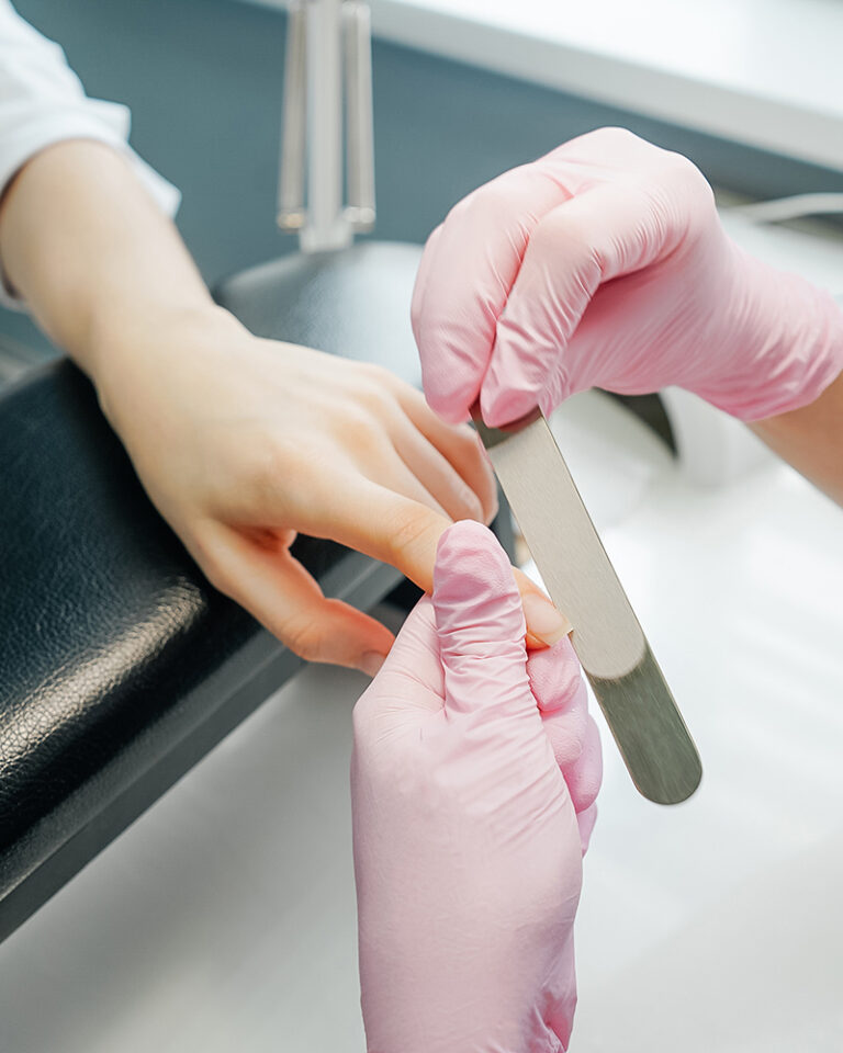 Side view of process of manicure, salon